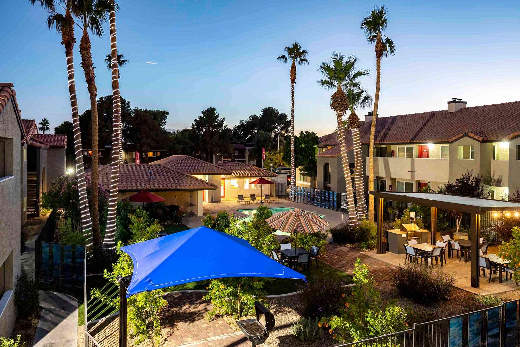 fifty101 apartments overview nightshot community pool outdoor seating eating area